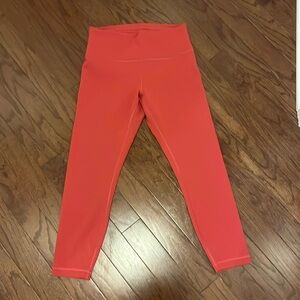 Pink/Red/Brick colored Lululemon Wunder Train leggings